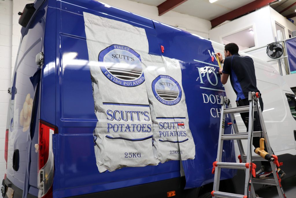 Kyle-Wrapping Scutt's potatoes van